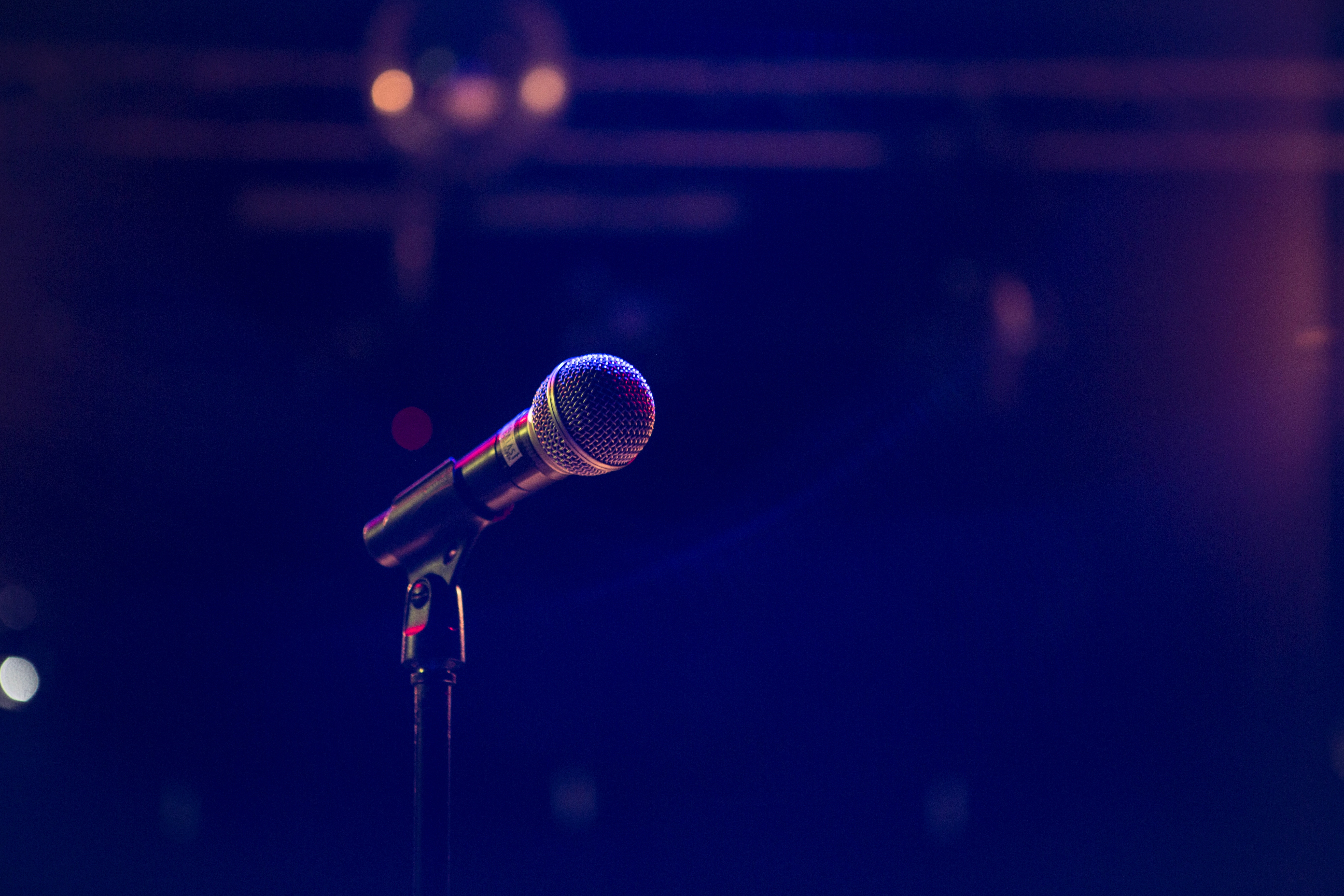 Image of a microphone with a dark background beyond.